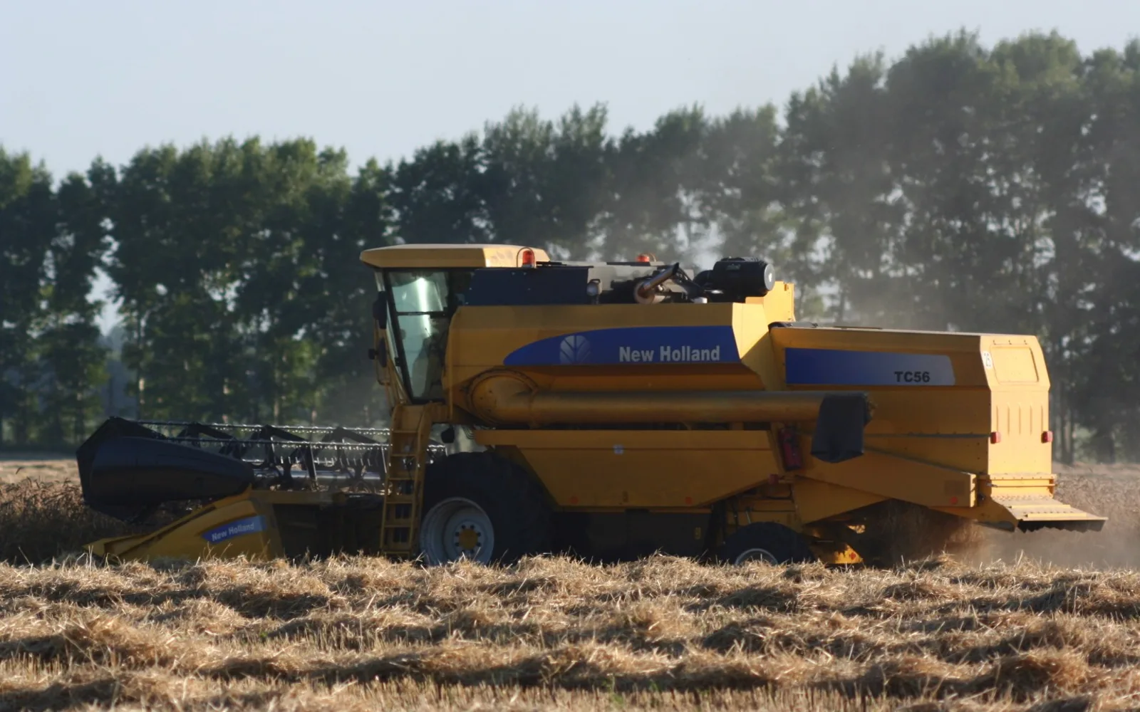 New Holland TC56 combine harvester working in agricultural field